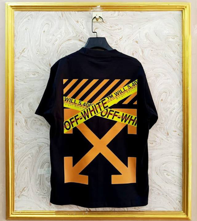 Black t-shirt with "Off-White™" design on a hanger against a decorative wall.