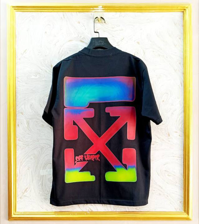 Black t-shirt with "Off-White™" design on a hanger against a decorative wall.