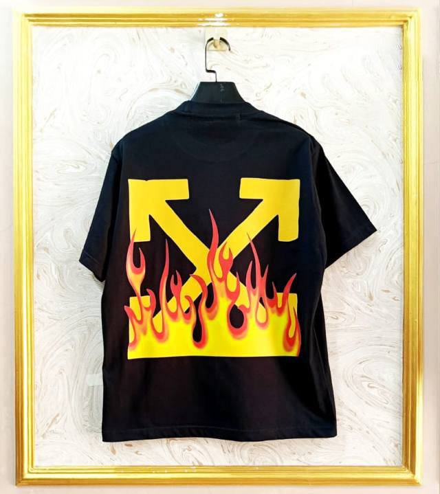 Black t-shirt with "Off-White™" design on a hanger against a decorative wall.