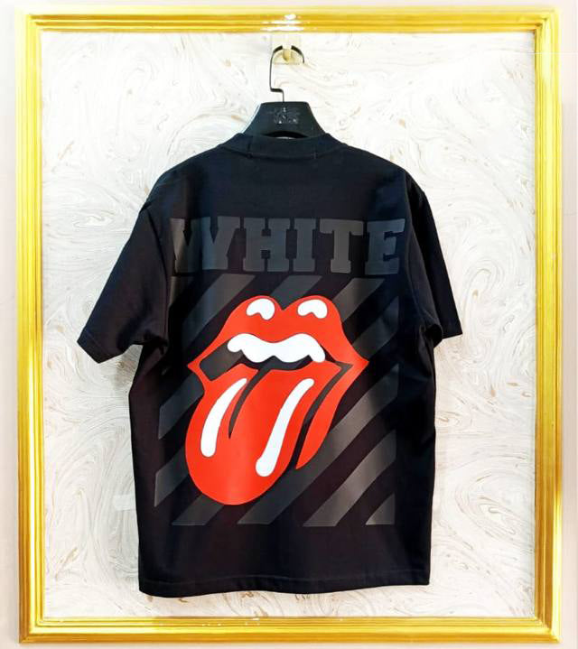 Black t-shirt with "Off-White™" design on a hanger against a decorative wall.