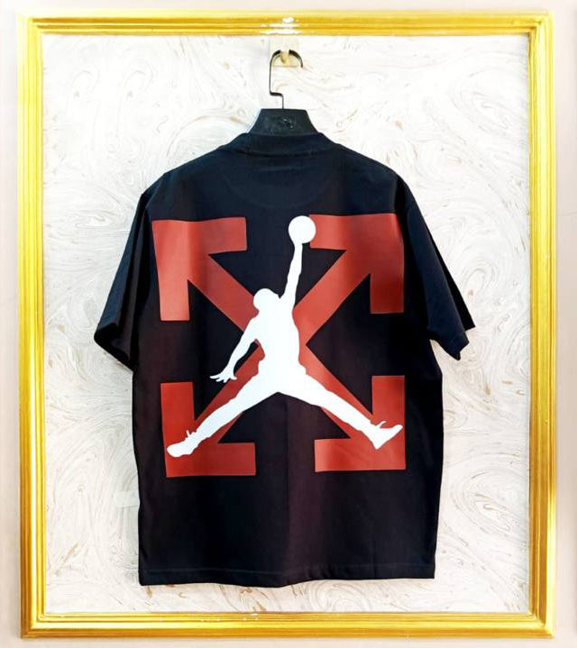 Black t-shirt with "Off-White™" design on a hanger against a decorative wall.