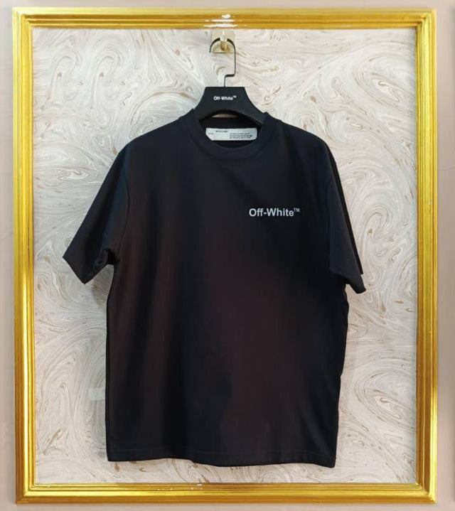 Black t-shirt with "Off-White™" logo on a hanger against a marble wall.