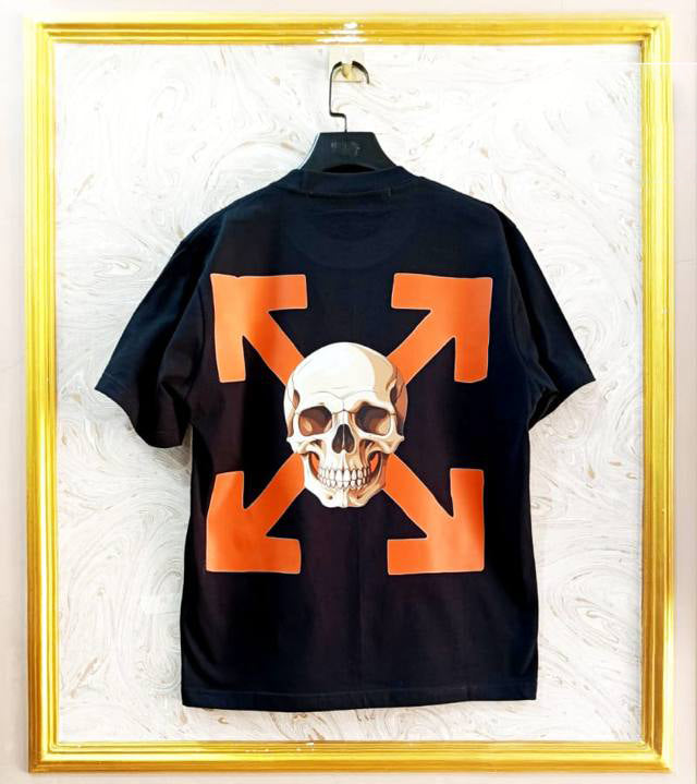 Black t-shirt with "Off-White™" design on a hanger against a decorative wall.