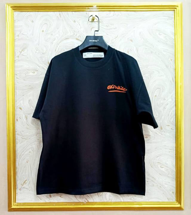 Black t-shirt with "Off-White™" logo on a hanger against a marble wall.