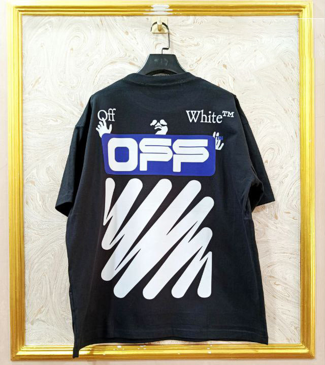 Black t-shirt with "Off-White™" design on a hanger against a decorative wall.