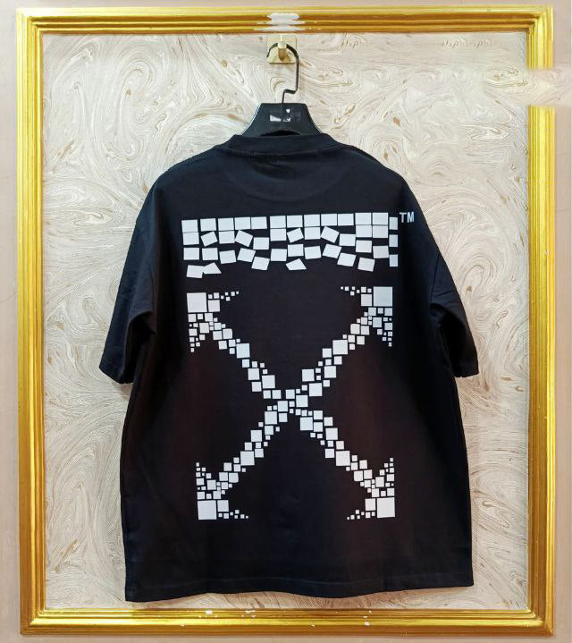 Black t-shirt with "Off-White™" design on a hanger against a decorative wall.