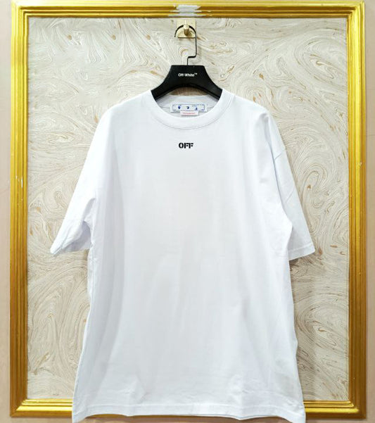 White t-shirt with "Off-White™" logo on a hanger against a marble wall.