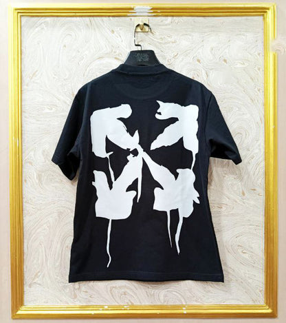 Black t-shirt with white graphic design on a textured wall background