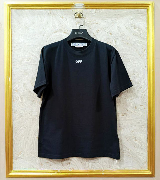 Black t-shirt with 'OFF' logo on a hanger against a textured wall.