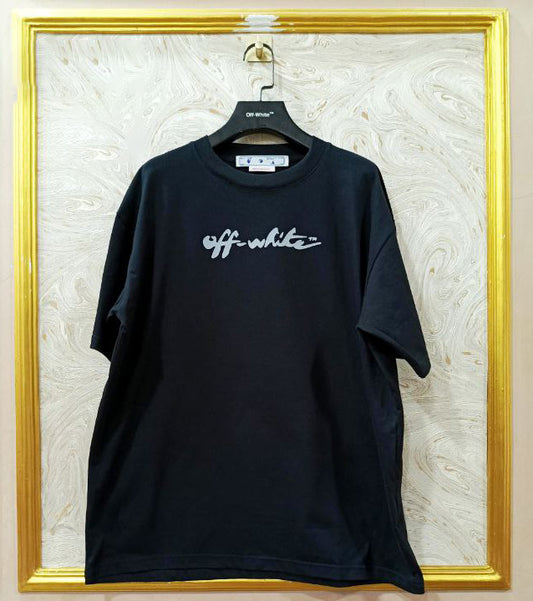Black t-shirt with "Off-White™" logo on a hanger against a marble wall.