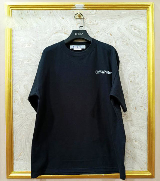 Black t-shirt with 'Off-White' logo on a hanger against a marble wall.