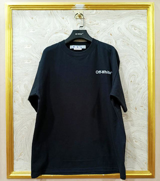 Black t-shirt with "Off-White™" logo on a hanger against a marble wall.