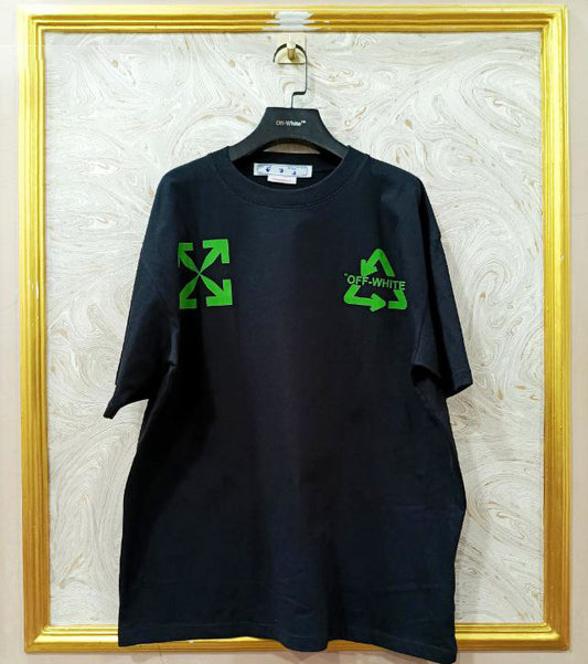 Black t-shirt with "Off-White™" logo on a hanger against a marble wall.
