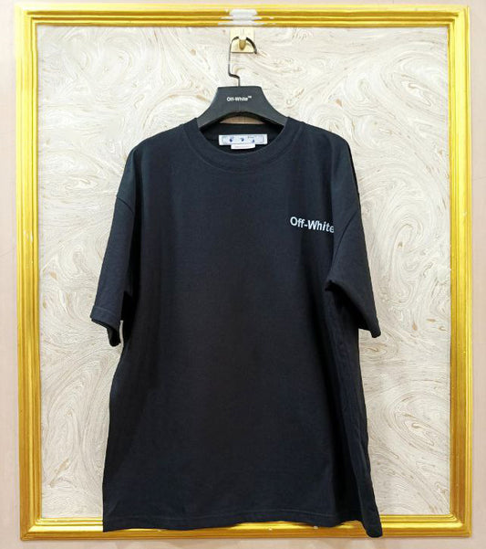 Black t-shirt with 'Off-White' logo on a hanger against a textured wall.