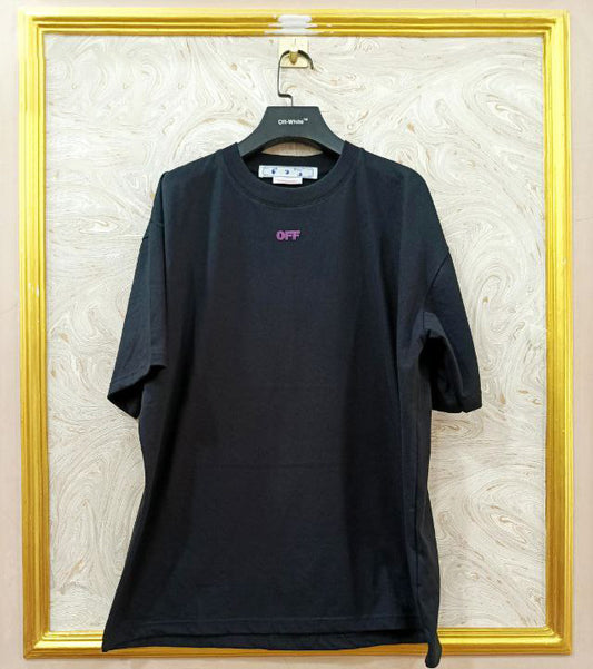 Black t-shirt with "Off-White™" logo on a hanger against a marble wall.