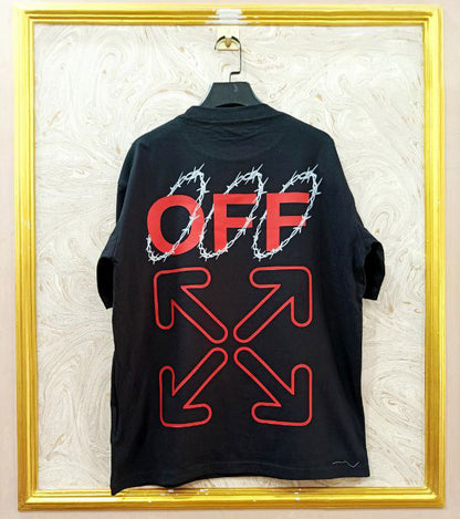 Black t-shirt with "Off-White™" design on a hanger against a decorative wall.