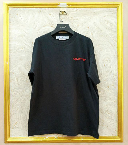 Black t-shirt with "Off-White™" logo on a hanger against a marble wall.