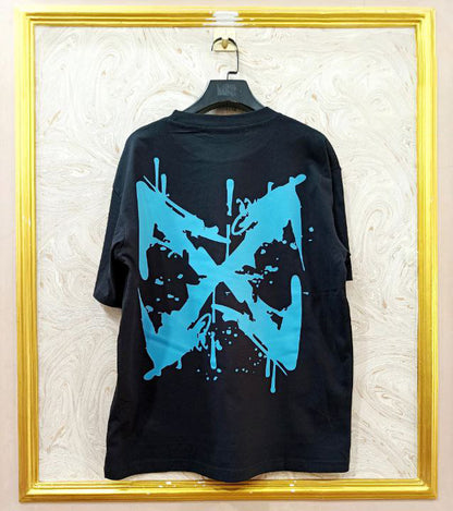 Black t-shirt with "Off-White™" design on a hanger against a decorative wall.