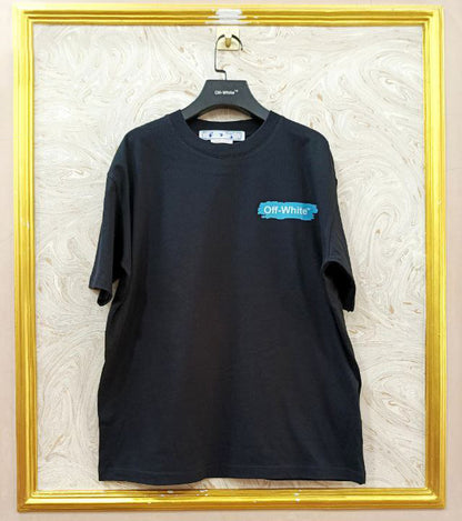 Black t-shirt with "Off-White™" logo on a hanger against a marble wall.