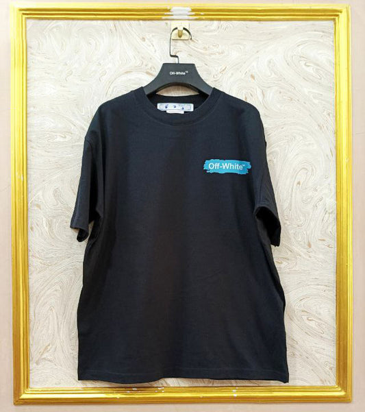 Black t-shirt with "Off-White™" logo on a hanger against a marble wall.