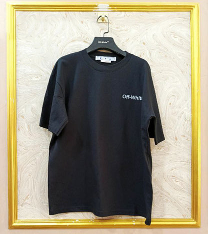 Black t-shirt with "Off-White™" logo on a hanger against a marble wall.