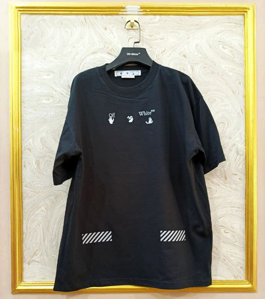 Black t-shirt with "Off-White™" logo on a hanger against a marble wall.