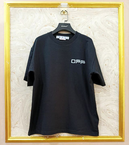 Black t-shirt with "Off-White™" logo on a hanger against a marble wall.