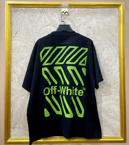 Black t-shirt with "Off-White™" design on a hanger against a decorative wall.