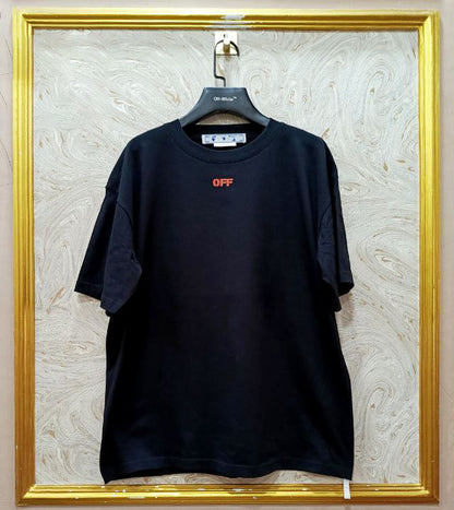 Black t-shirt with "Off-White™" logo on a hanger against a marble wall.
