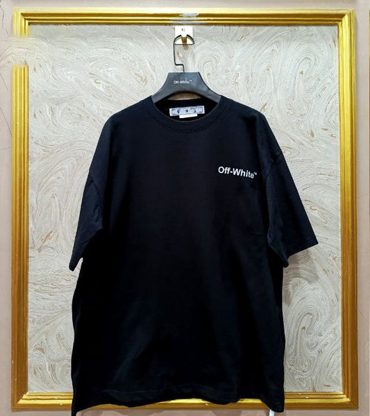 Black t-shirt with "Off-White™" logo on a hanger against a marble wall.