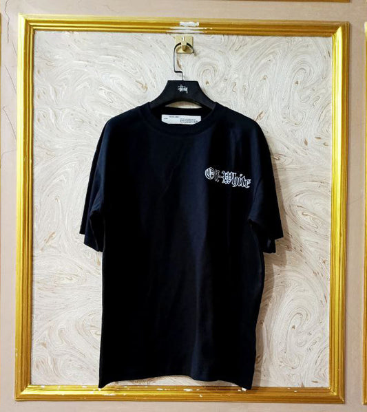 Black t-shirt with "Off-White™" logo on a hanger against a marble wall.