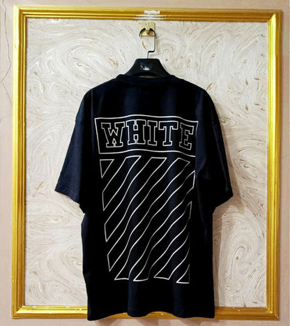 Black t-shirt with "Off-White™" design on a hanger against a decorative wall.