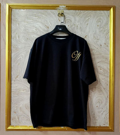 Black t-shirt with "Off-White™" logo on a hanger against a marble wall.