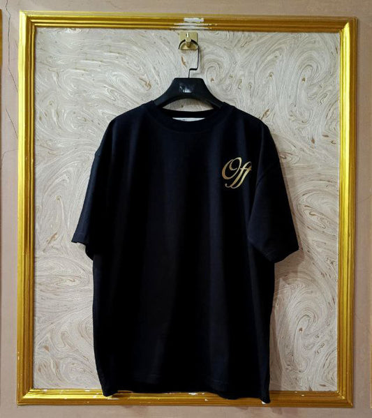 Black t-shirt with "Off-White™" logo on a hanger against a marble wall.