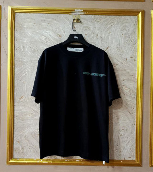 Black t-shirt with "Off-White™" logo on a hanger against a marble wall.
