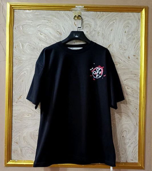 Black t-shirt with "Off-White™" logo on a hanger against a marble wall.