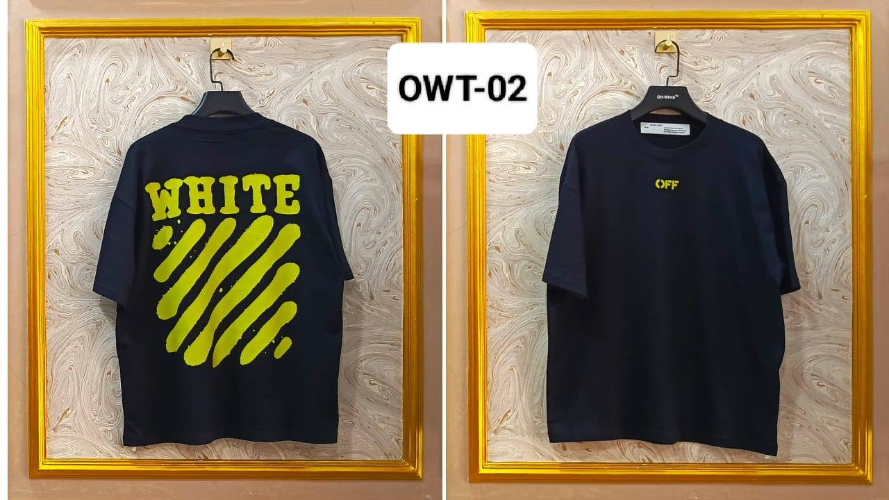 Two black t-shirts with yellow text on hangers against a decorative wall.