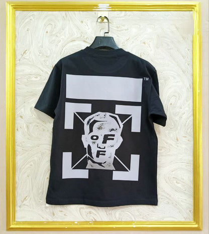 Black t-shirt with "Off-White™" design on a hanger against a decorative wall.