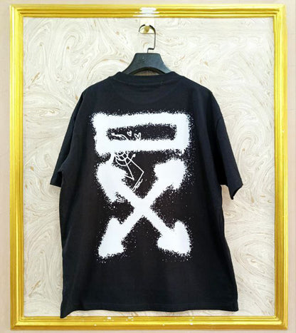 Black t-shirt with "Off-White™" design on a hanger against a decorative wall.