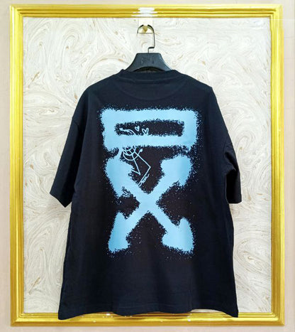 Black t-shirt with "Off-White™" design on a hanger against a decorative wall.