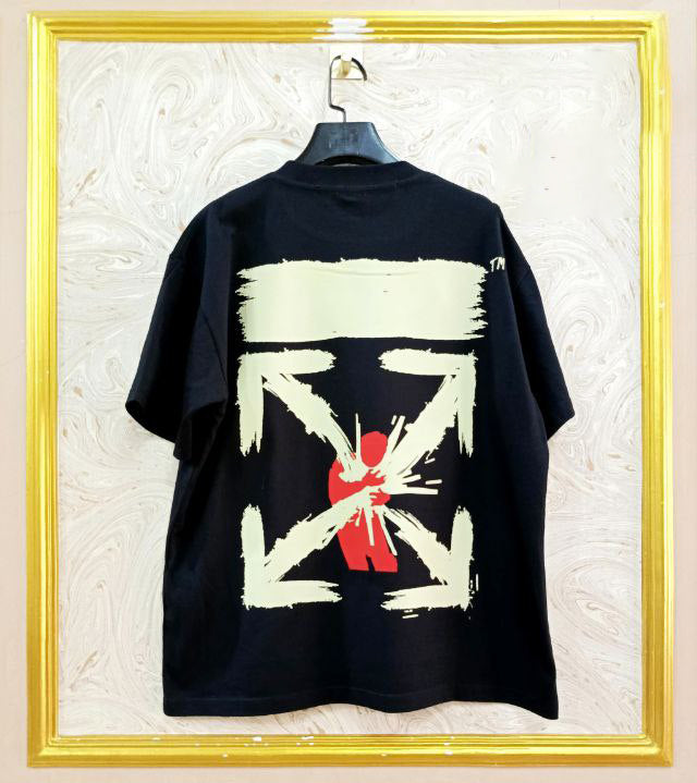 Black t-shirt with "Off-White™" design on a hanger against a decorative wall.