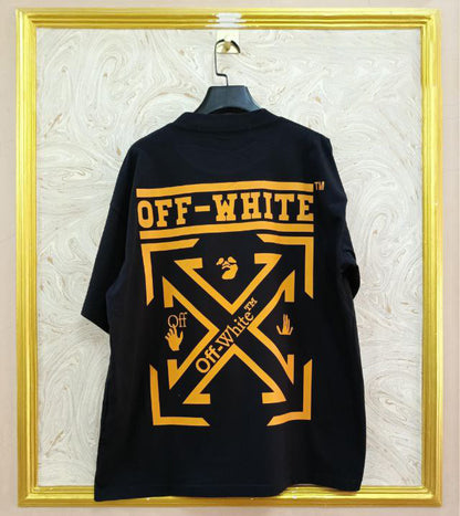 Black t-shirt with "Off-White™" design on a hanger against a decorative wall.