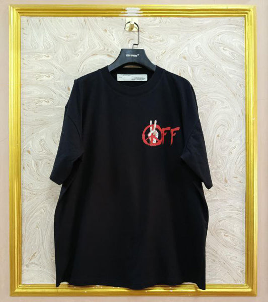 Black t-shirt with "Off-White™" logo on a hanger against a marble wall.
