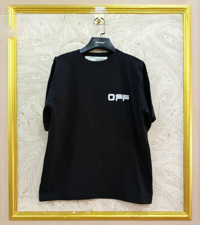 Black t-shirt with "Off-White™" logo on a hanger against a marble wall.