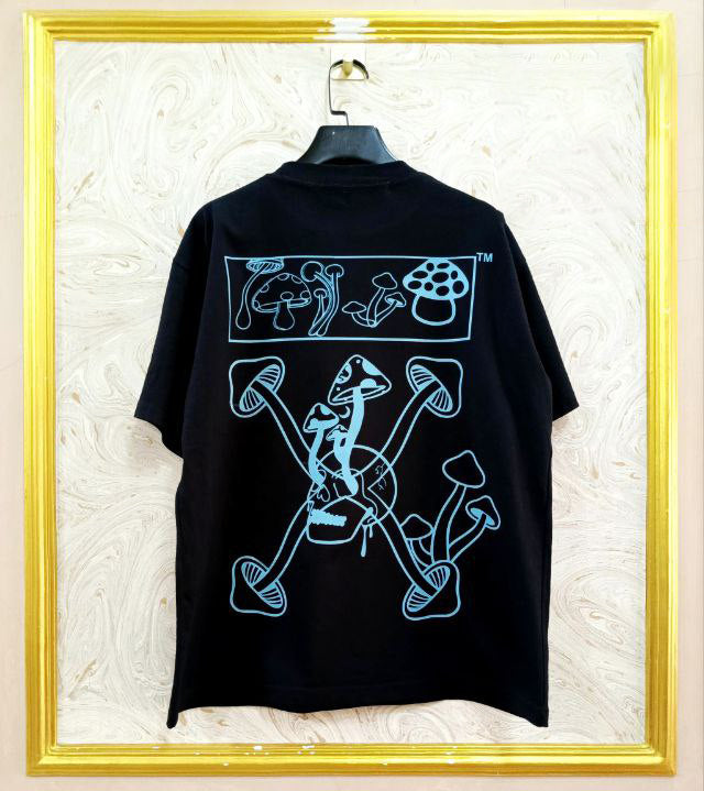 Black t-shirt with "Off-White™" design on a hanger against a decorative wall.