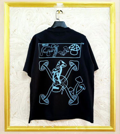 Black t-shirt with "Off-White™" design on a hanger against a decorative wall.