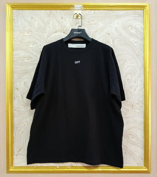 Black t-shirt with "Off-White™" logo on a hanger against a marble wall.