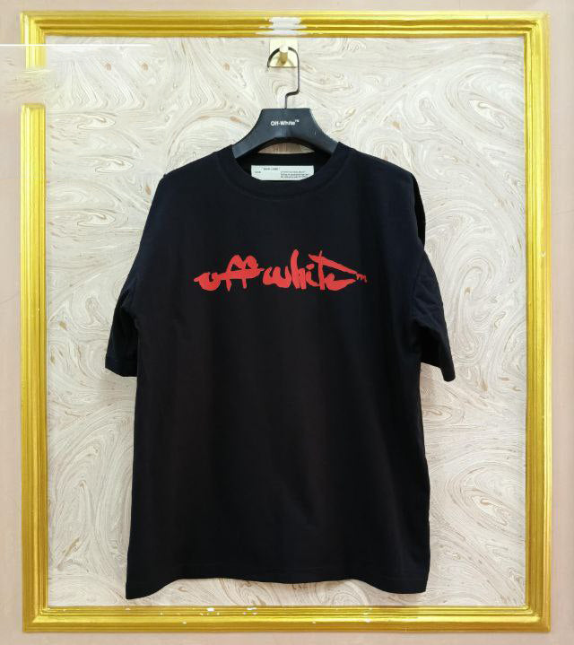 Black t-shirt with "Off-White™" logo on a hanger against a marble wall.