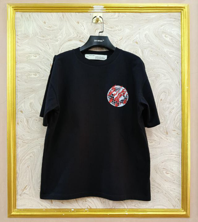 Black t-shirt with "Off-White™" logo on a hanger against a marble wall.