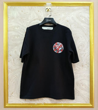 Black t-shirt with "Off-White™" logo on a hanger against a marble wall.